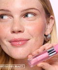 Sweet Treat Lip Oil in Melon Paradise – on model holding the bottle