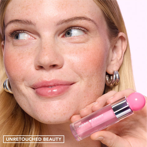 Sweet Treat Lip Oil in Melon Paradise – on model holding the bottle